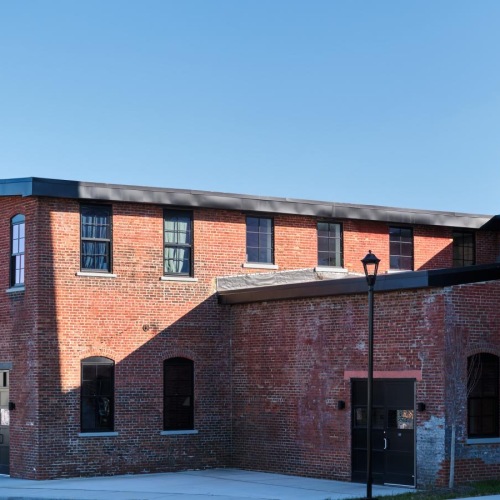 a brick building with a tall chimney