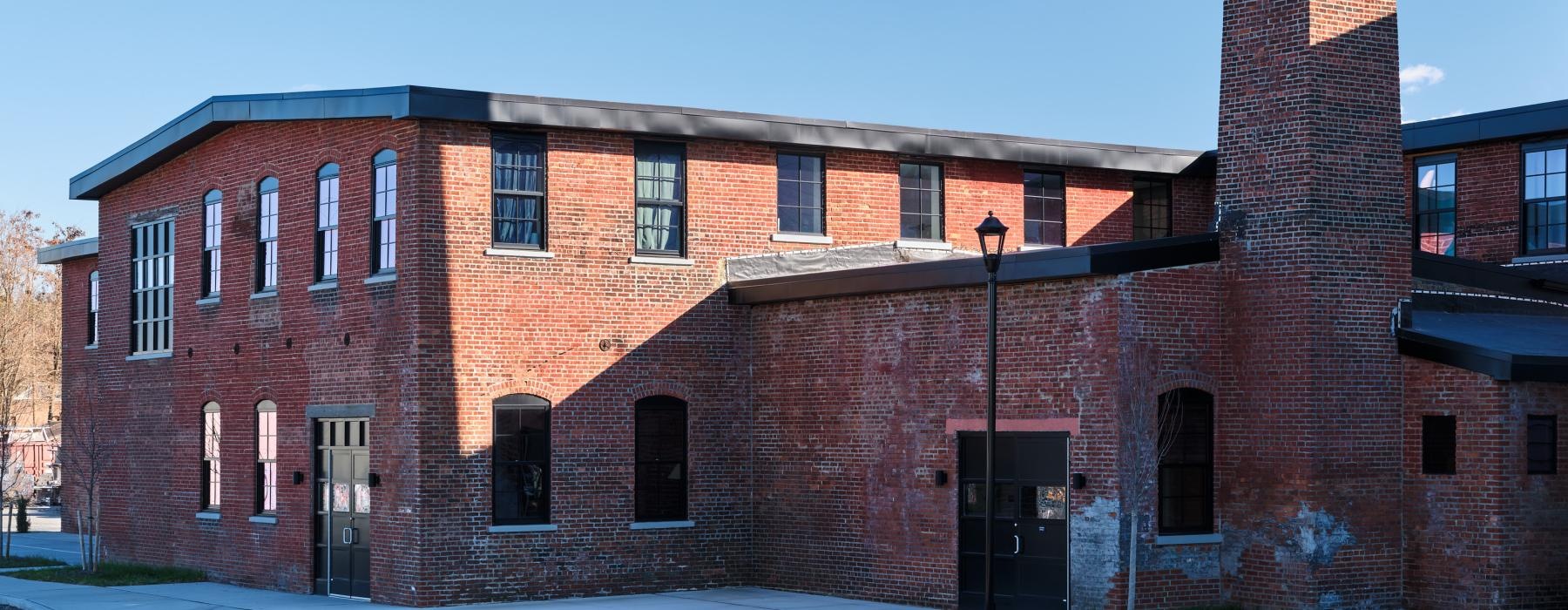 a brick building with a tall chimney